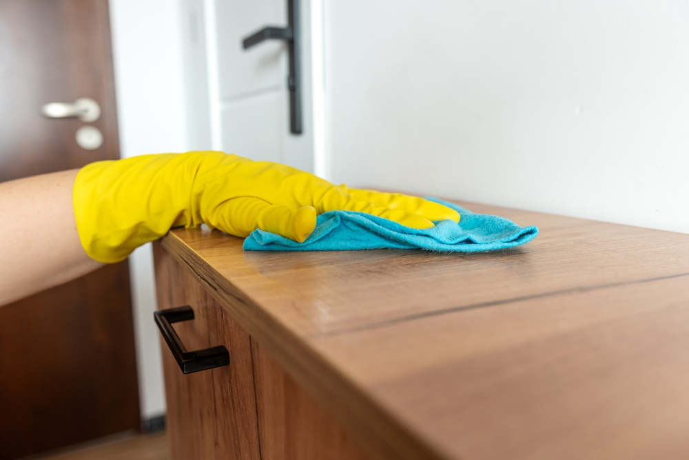 dusting a cabinet