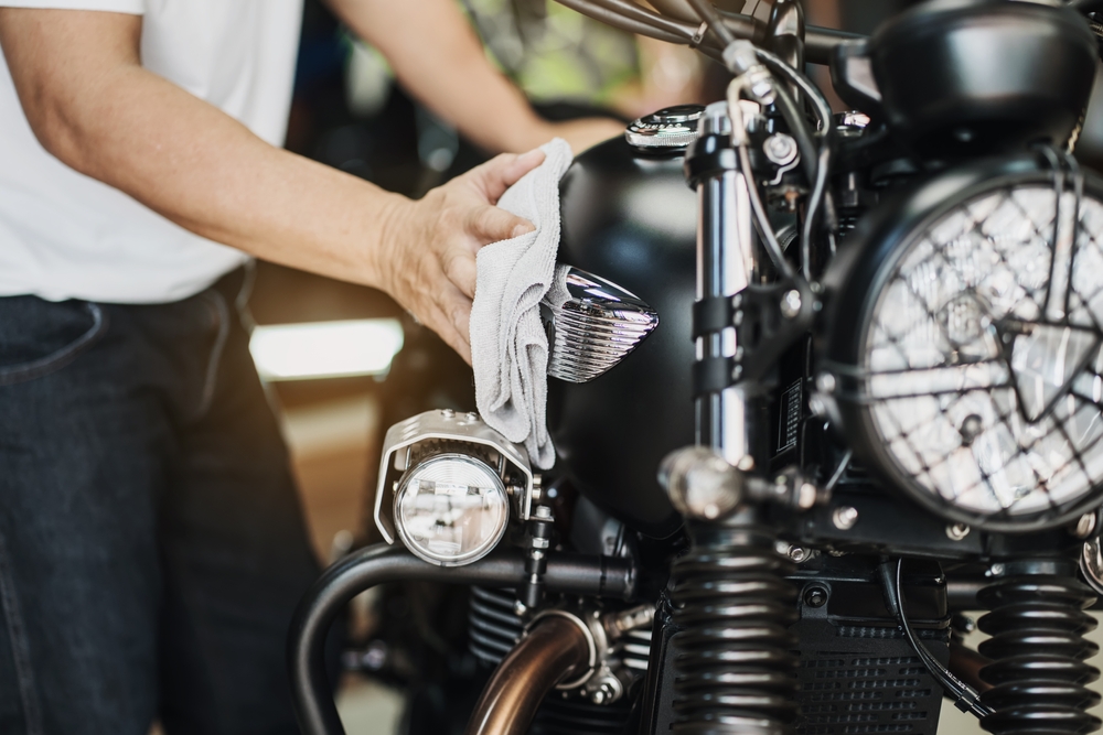 wiping motorcycle with microfiber cloth